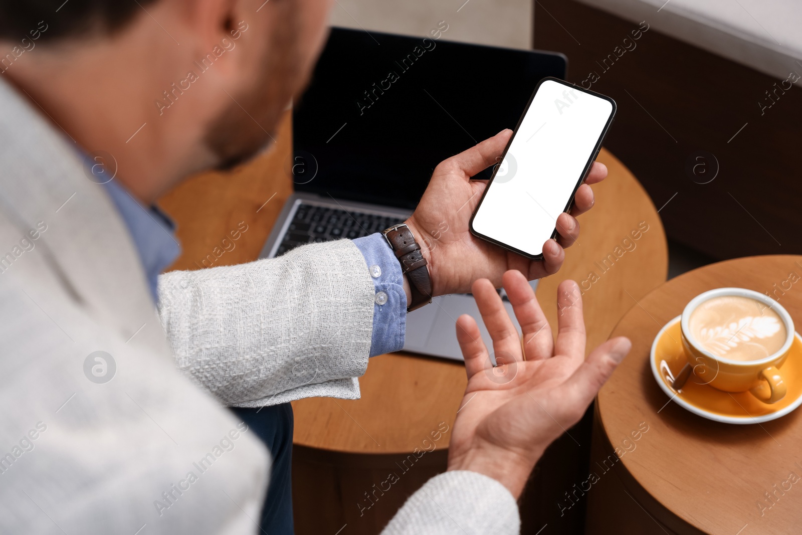 Photo of Man using his smartphone in cafe, closeup