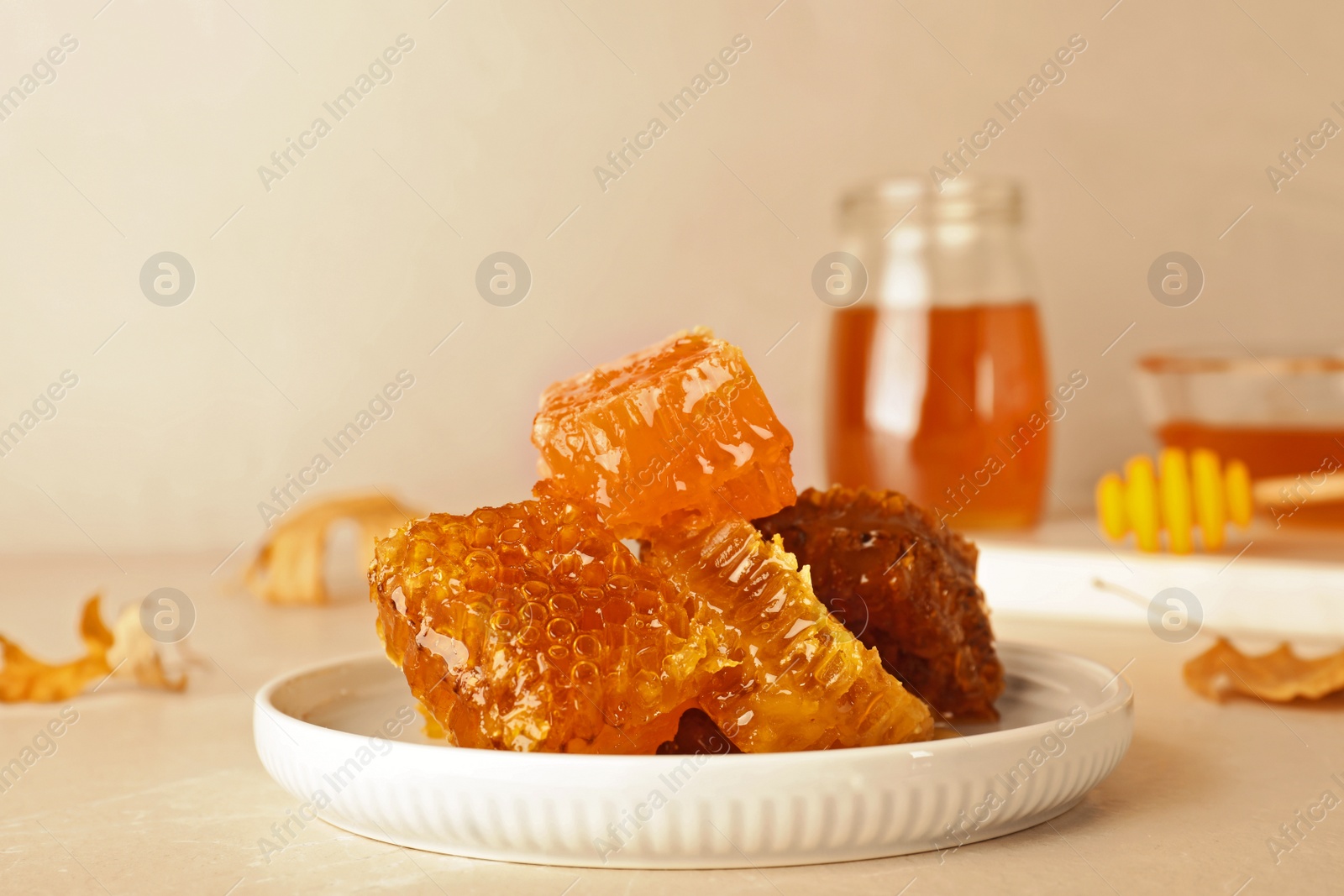 Photo of Plate with fresh tasty honeycombs on table