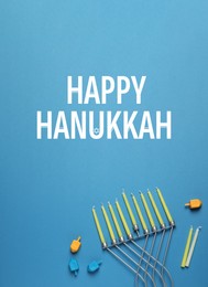 Happy Hanukkah. Menorah, candles and dreidels on light blue background, flat lay