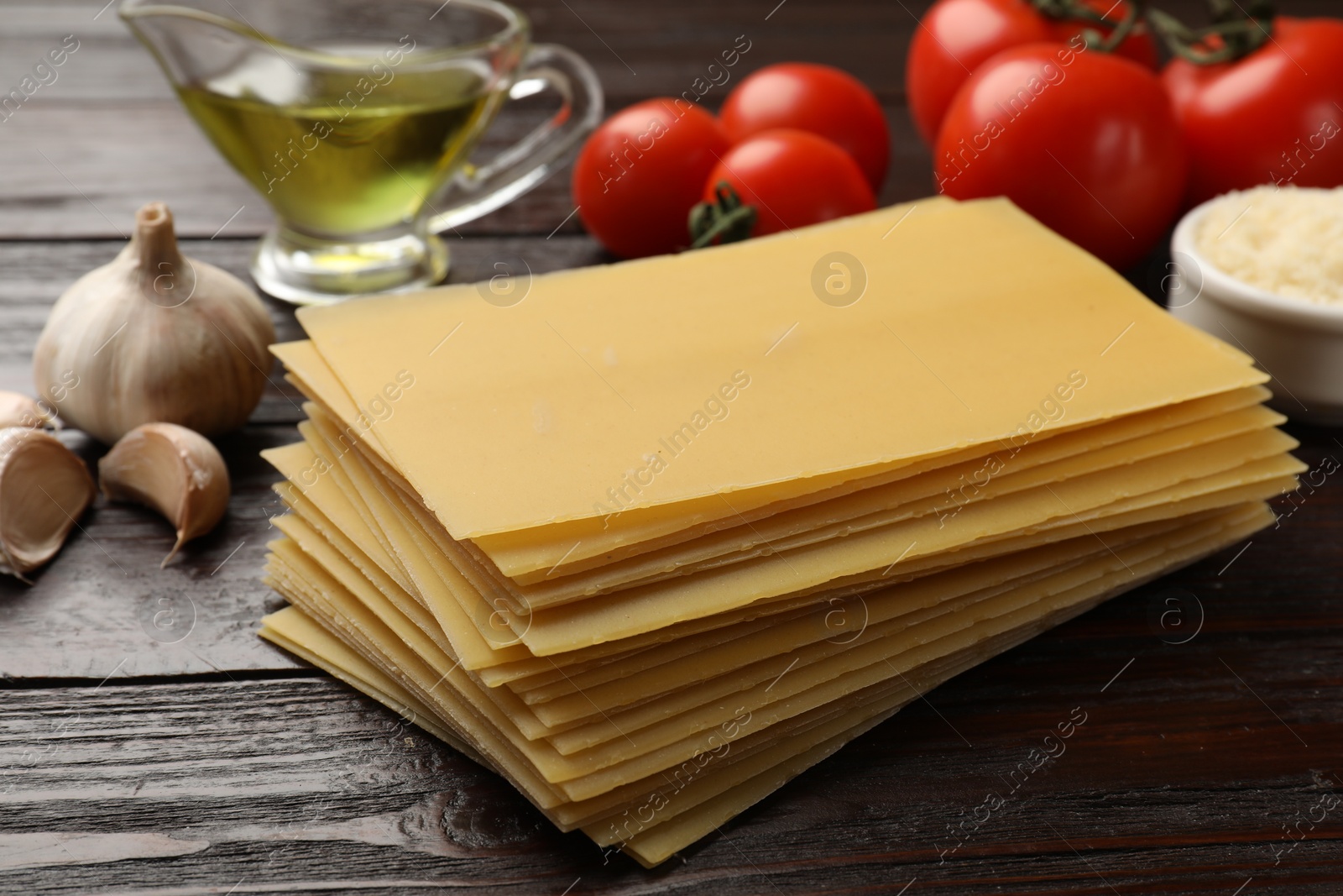 Photo of Ingredients for lasagna on wooden table, closeup