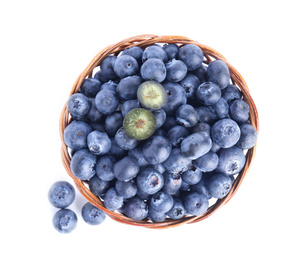 Fresh tasty blueberries in wicker basket isolated on white, top view