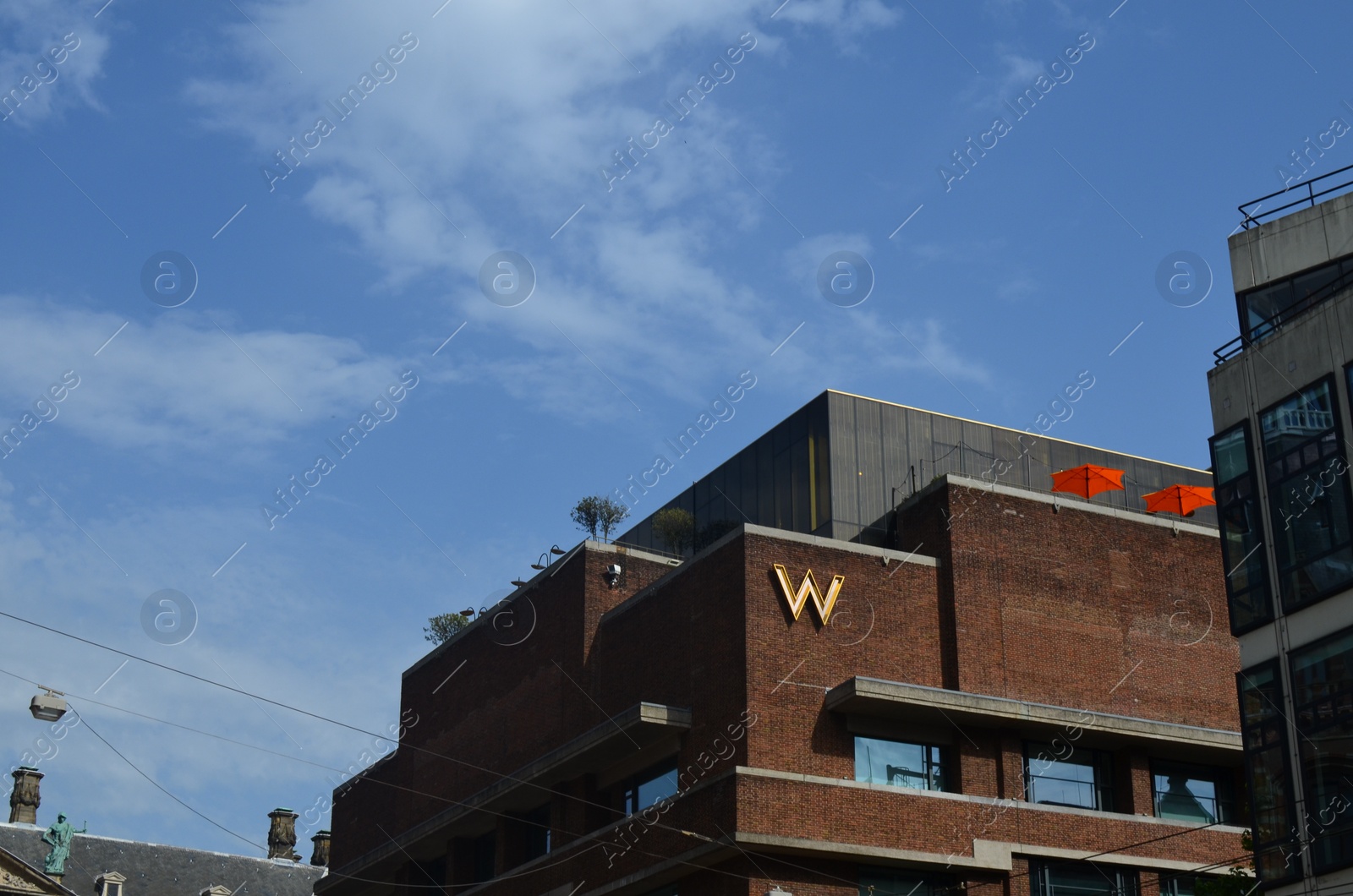 Photo of Amsterdam, Netherlands - June 18, 2022: Modern buildings against blue sky