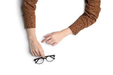 Photo of Woman with glasses on white background, top view. Closeup of hands