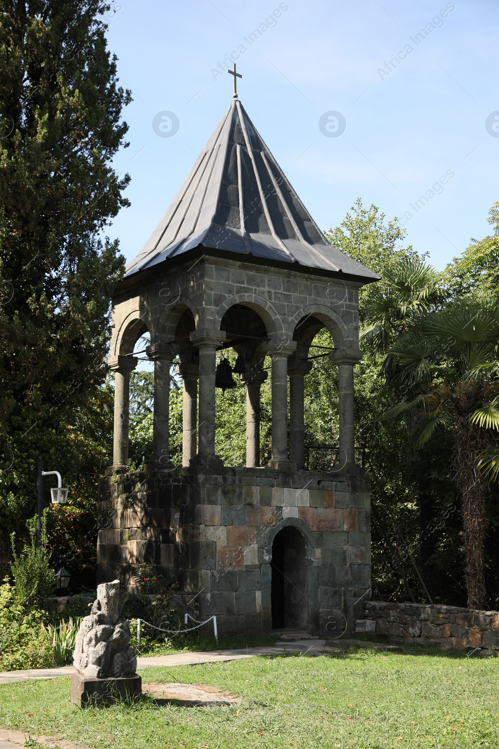 Photo of Exterior of beautiful bell tower in park on sunny day