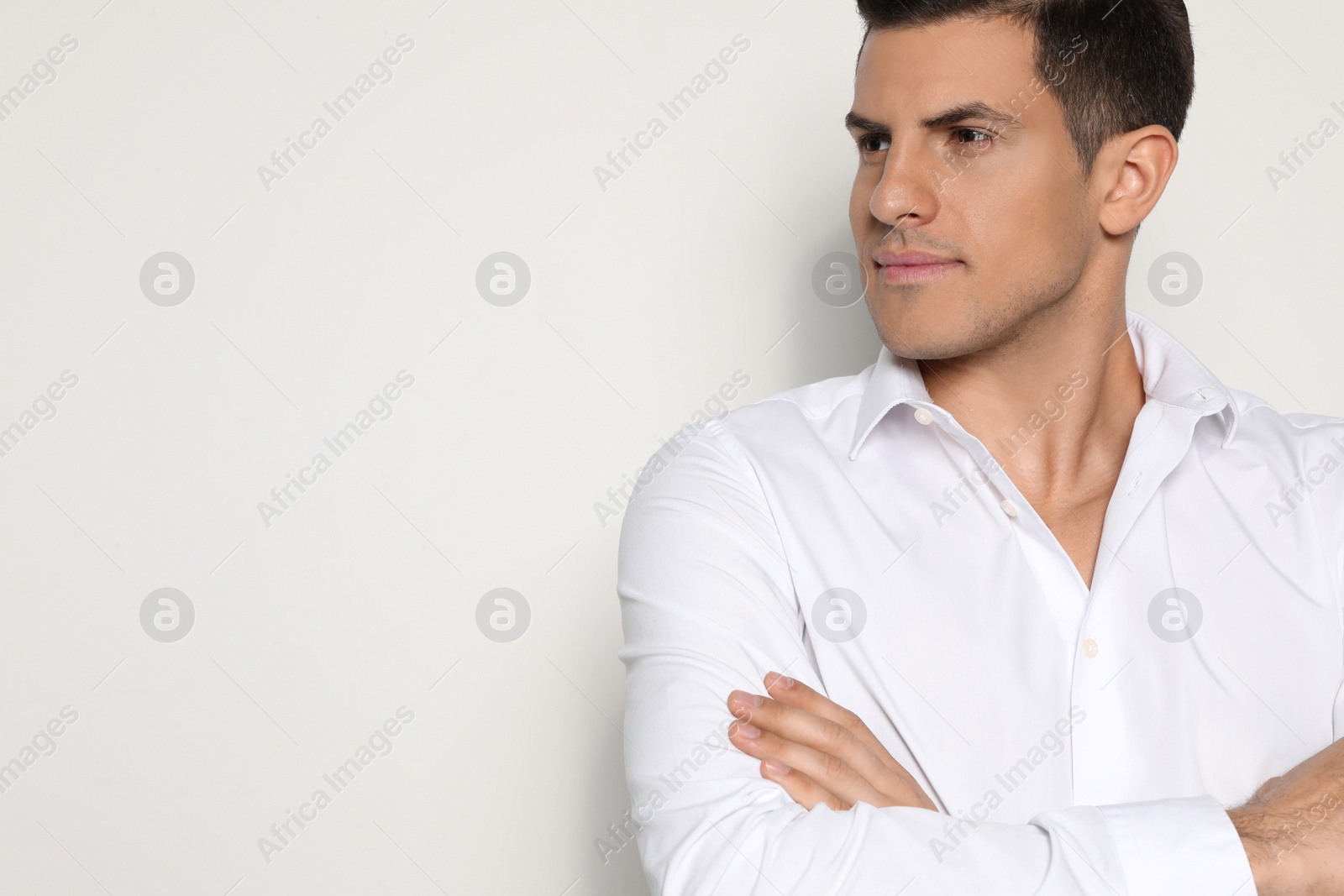 Photo of Portrait of handsome man on light background, closeup. Space for text