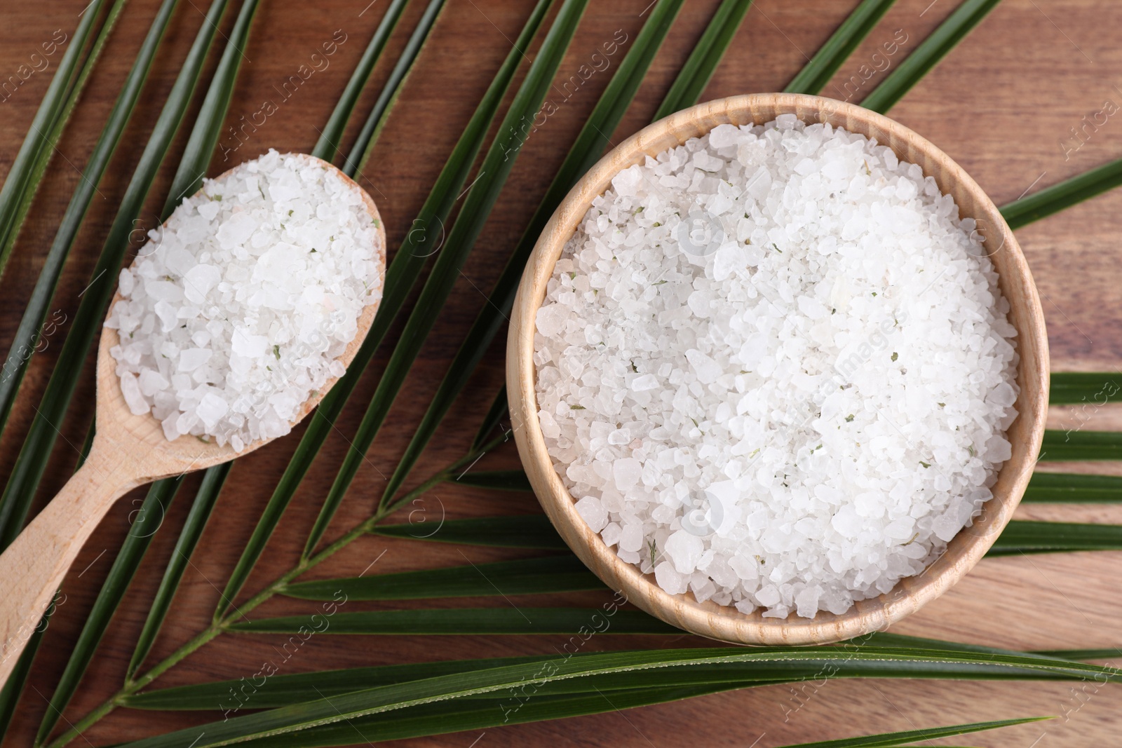 Photo of Flat lay composition with white sea salt on wooden background. Spa treatment