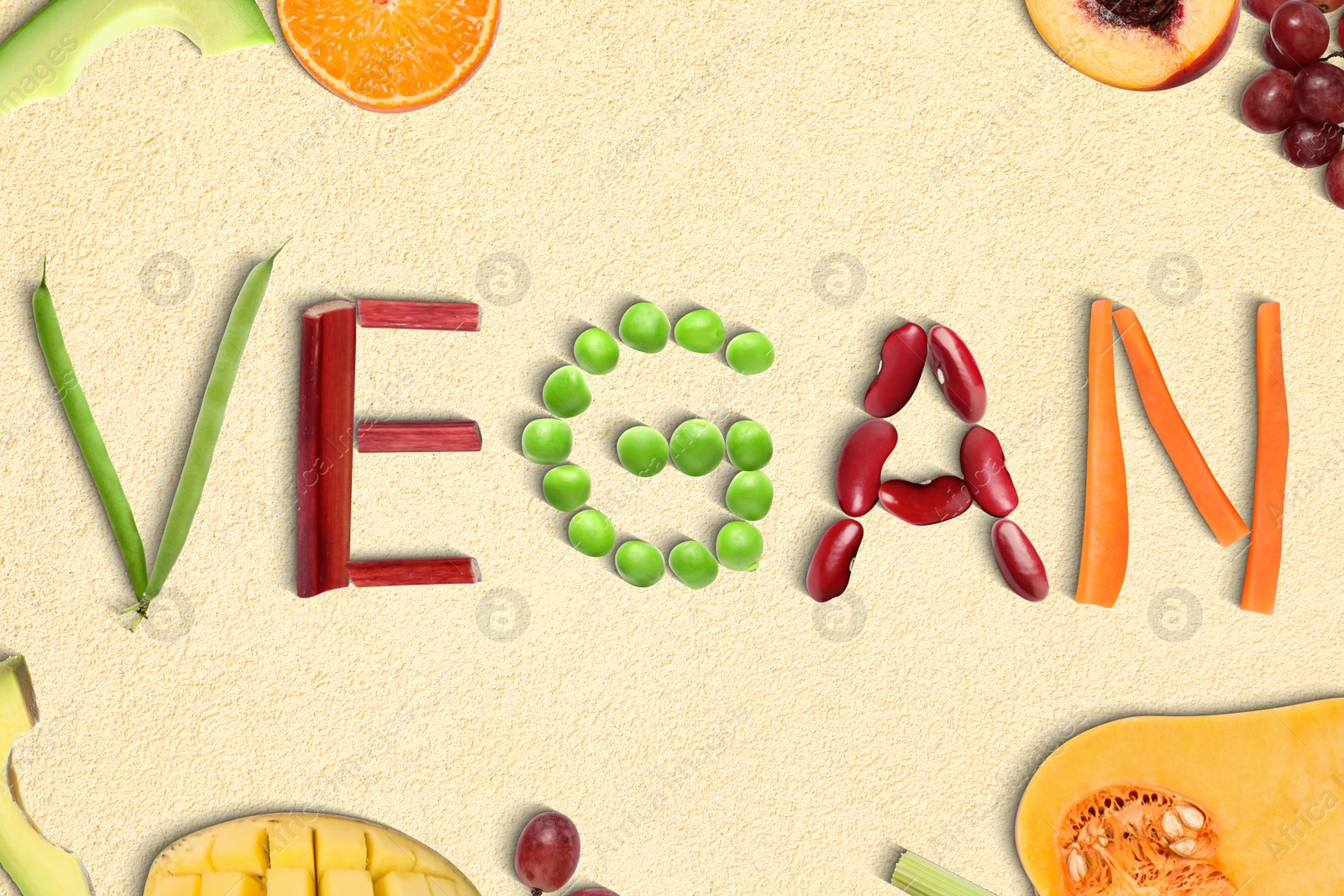 Image of Word VEGAN made of different fresh tasty vegetables on beige background, flat lay