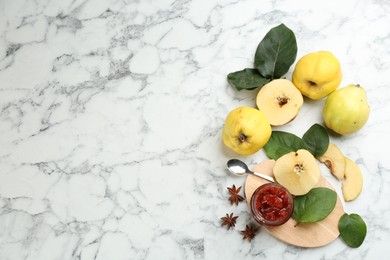 Delicious quince jam and fruits on white marble table, flat lay. Space for text