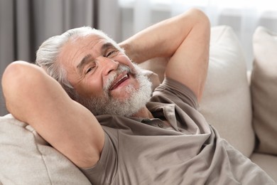 Photo of Portrait of senior man on sofa at home