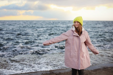 Portrait of beautiful young woman near sea