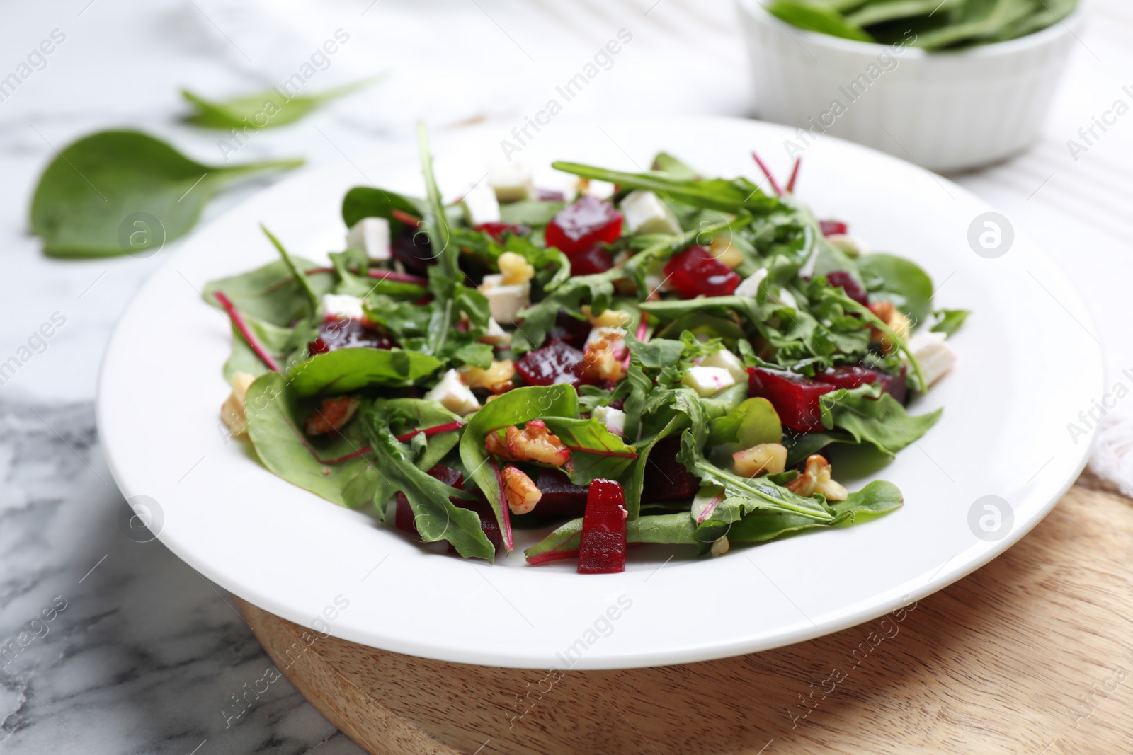 Photo of Delicious beet salad served on white marble table, closeup