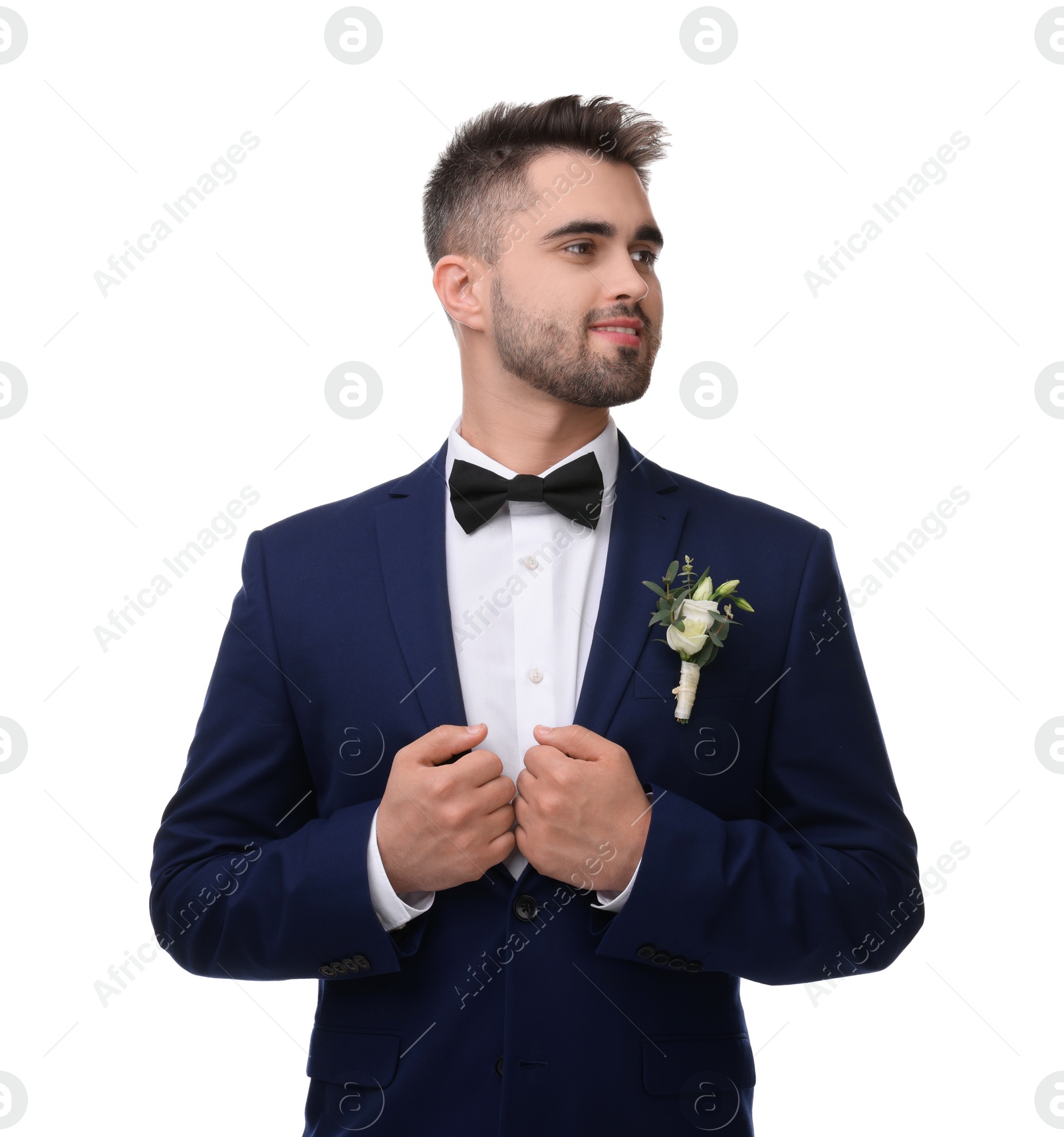 Photo of Handsome young groom with boutonniere on white background. Wedding accessory