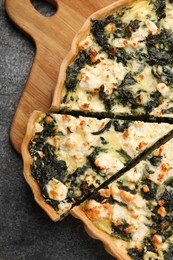Photo of Delicious homemade spinach quiche on gray table, top view