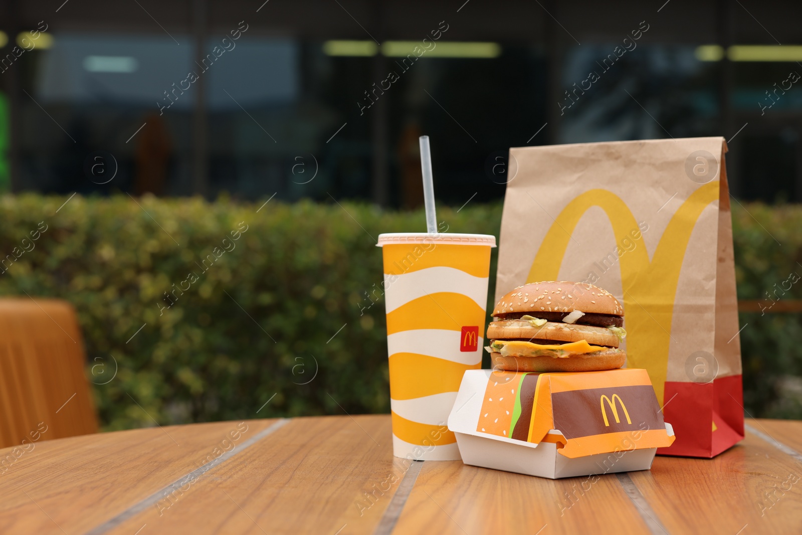 Photo of Lviv, Ukraine - October 9, 2023: McDonald's menu on wooden table outdoors, space for text