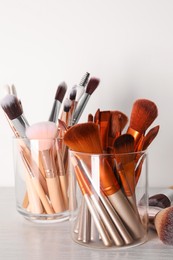 Photo of Set of professional brushes on wooden table