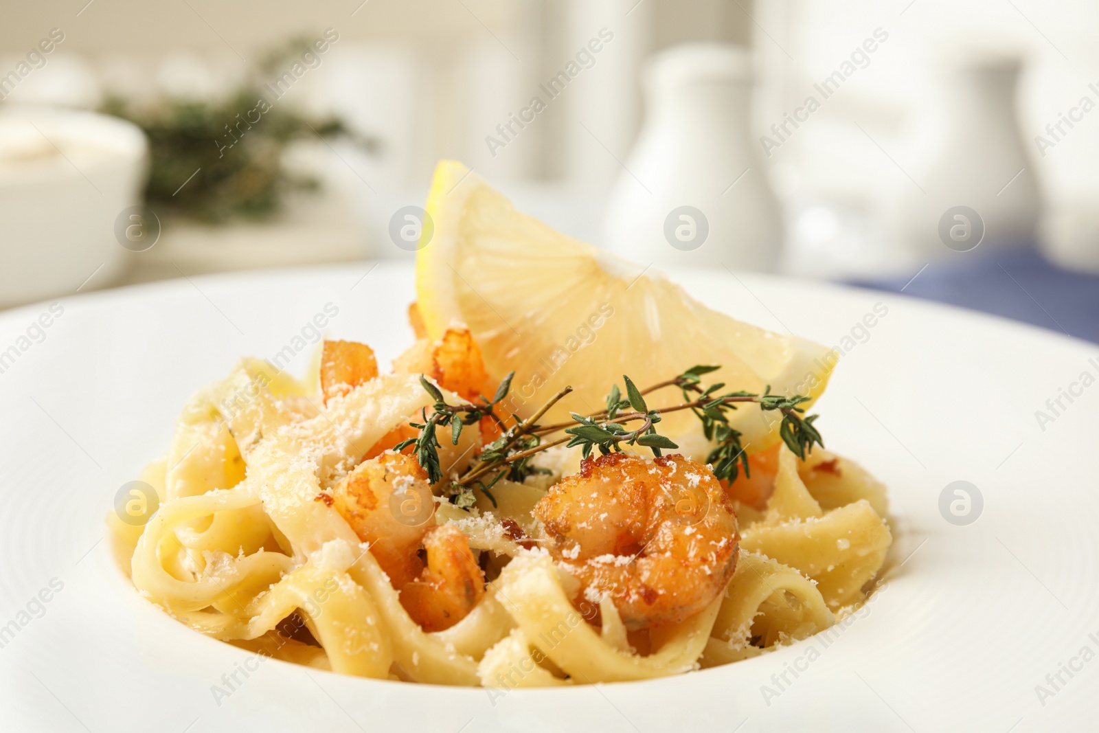 Photo of Delicious pasta with shrimps on plate, closeup