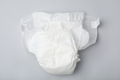 Photo of Baby diaper on light grey background, top view