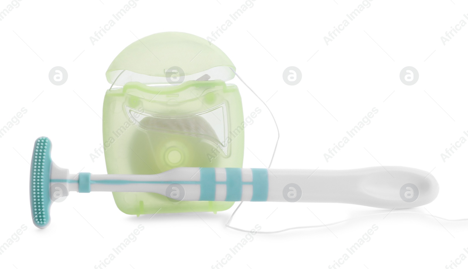 Photo of New tongue cleaner and dental floss on white background