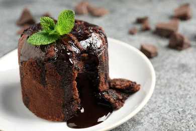 Delicious warm chocolate lava cake on grey table, closeup