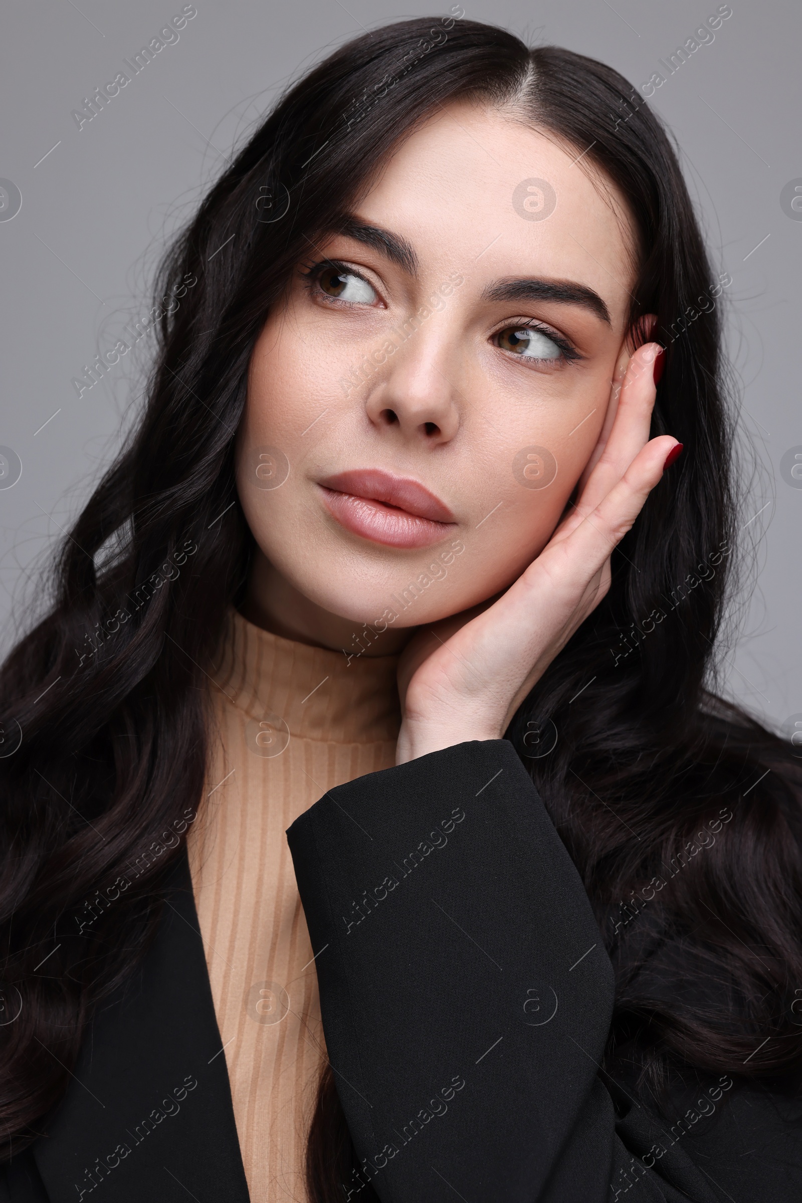 Photo of Beautiful woman in black jacket on gray background