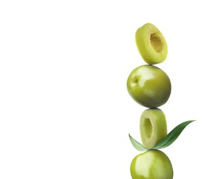 Image of Cut and whole olives with leaf on white background