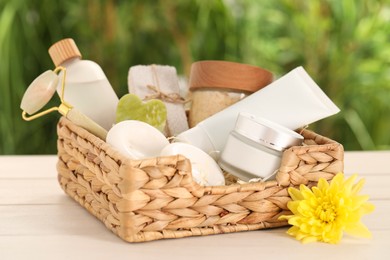 Photo of Spa gift set with different products on white wooden table against blurred background