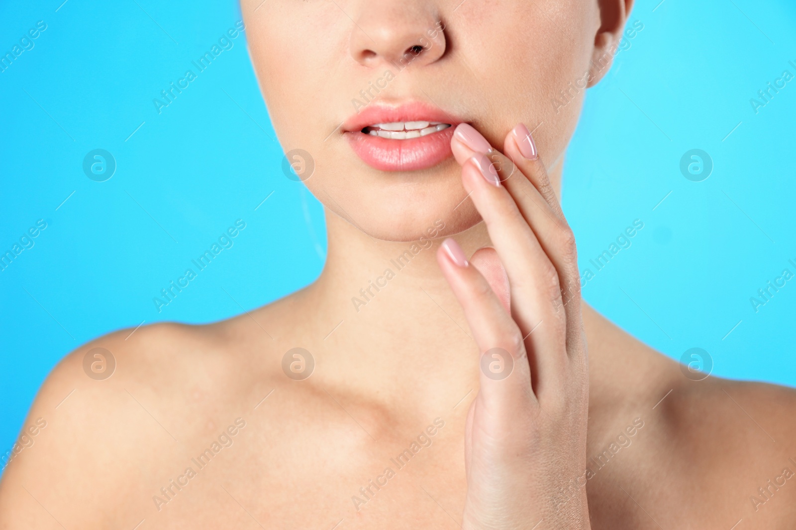 Photo of Closeup view of beautiful young woman on color background. Lips contouring, skin care and cosmetic surgery concept