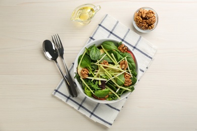 Delicious fresh celery salad served on white wooden table, flat lay