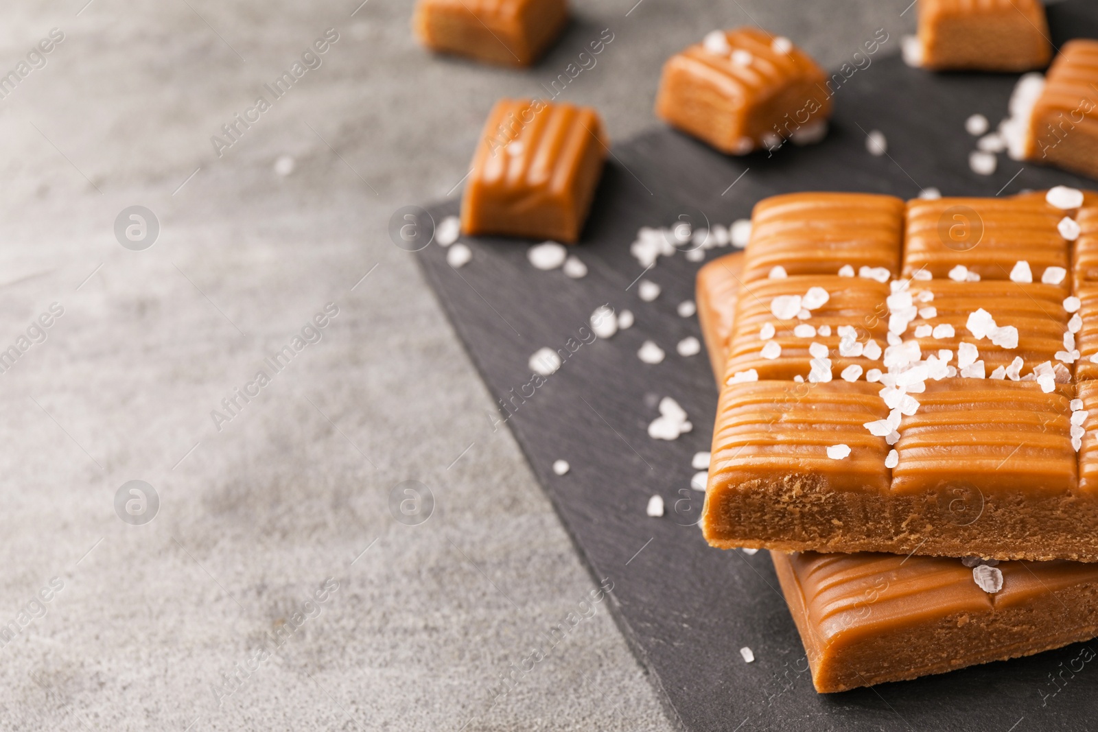 Photo of Salted caramel on light grey table, closeup. Space for text