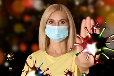 Image of Be healthy - boost your immunity. Woman in protective mask showing stop gesture to viruses