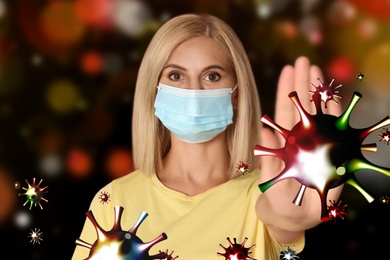 Be healthy - boost your immunity. Woman in protective mask showing stop gesture to viruses