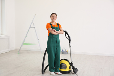 Photo of Professional young janitor vacuuming indoors. Cleaning service