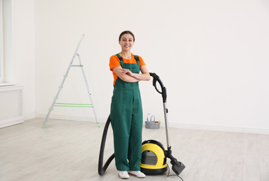 Professional young janitor vacuuming indoors. Cleaning service