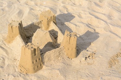 Photo of Beautiful sand castle on beach. Space for text