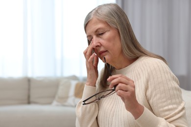 Photo of Overwhelmed woman suffering at home. Space for text