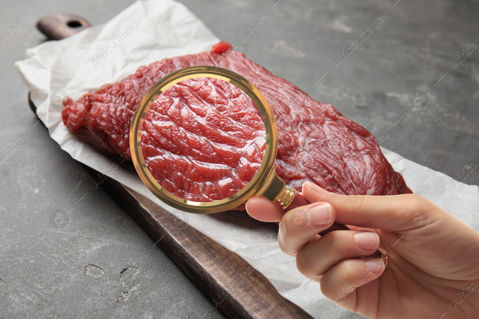 Image of Woman with magnifying glass focusing on fresh raw meat, closeup. Food control 