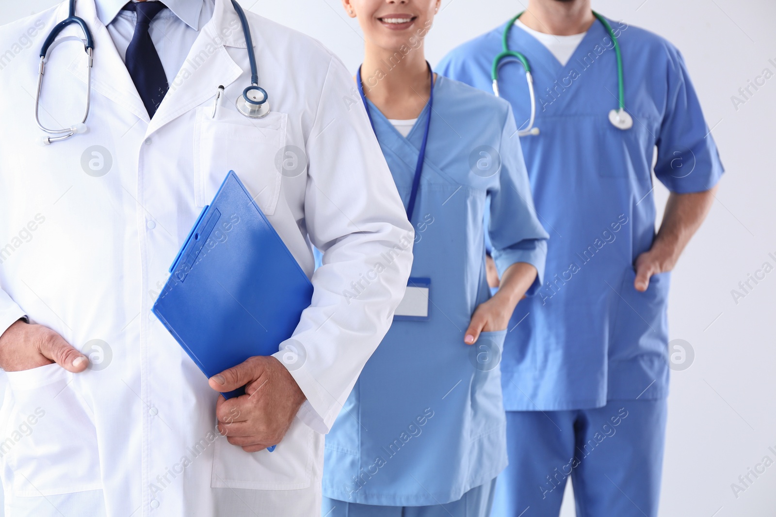 Photo of Doctors against light background, closeup. Medical service