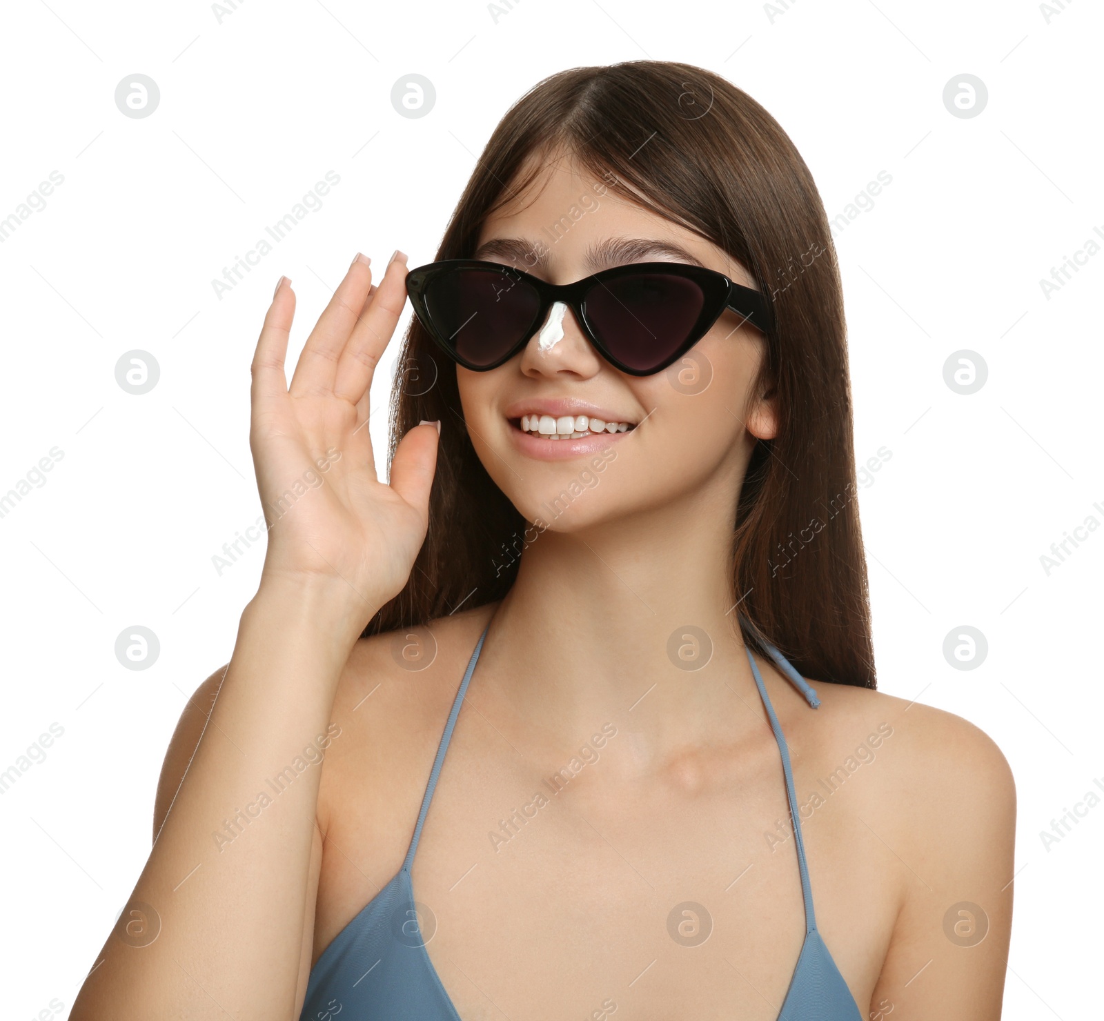 Photo of Teenage girl with sun protection cream on her nose against white background