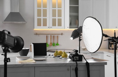 Photo of Professional equipment and many pears on table in kitchen. Food photo