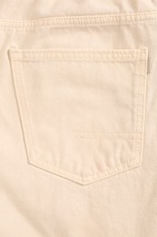 Photo of Beige jeans with back pocket as background, closeup