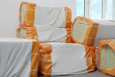 Photo of Packages of thermal insulation material in room