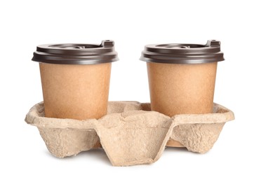 Takeaway paper coffee cups in cardboard holder on white background