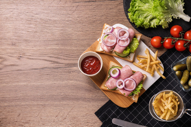 Photo of Delicious sandwiches served on wooden table, flat lay. Space for text