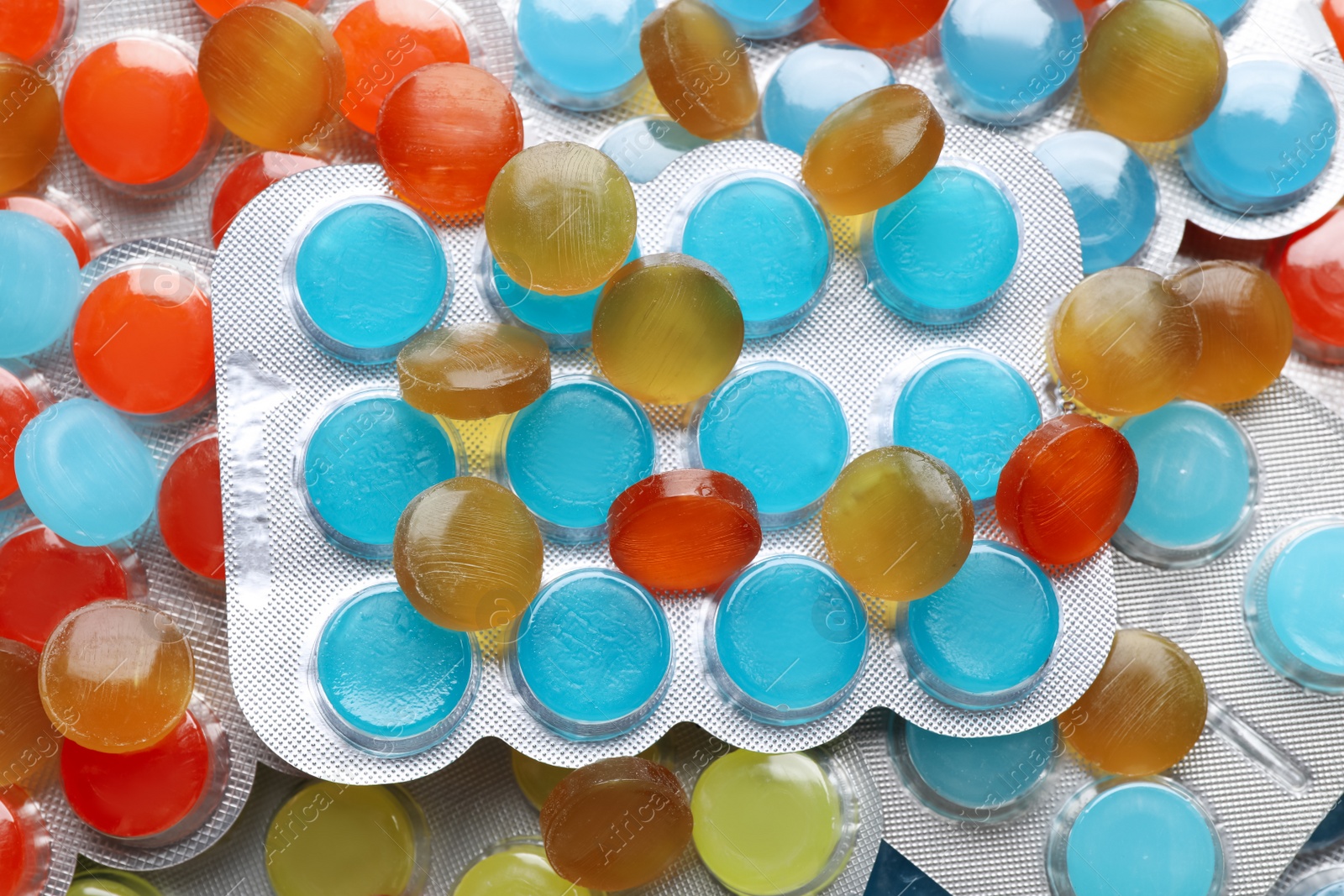 Photo of Many colorful cough drops as background, top view