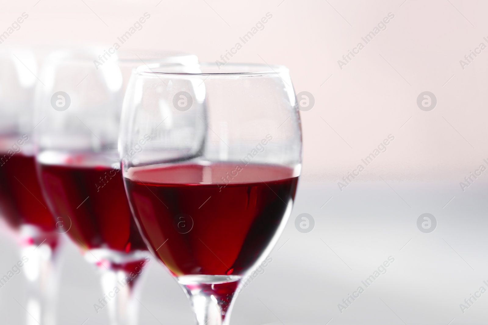 Photo of Glasses with delicious red wine, closeup