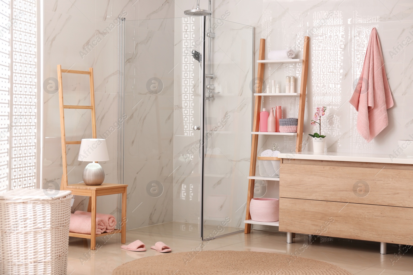 Photo of Modern bathroom interior with decorative ladder and shower stall