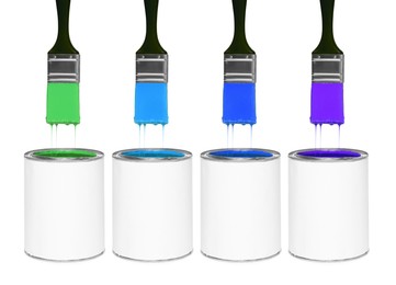 Image of Brushes with colorful paints in air over cans on white background