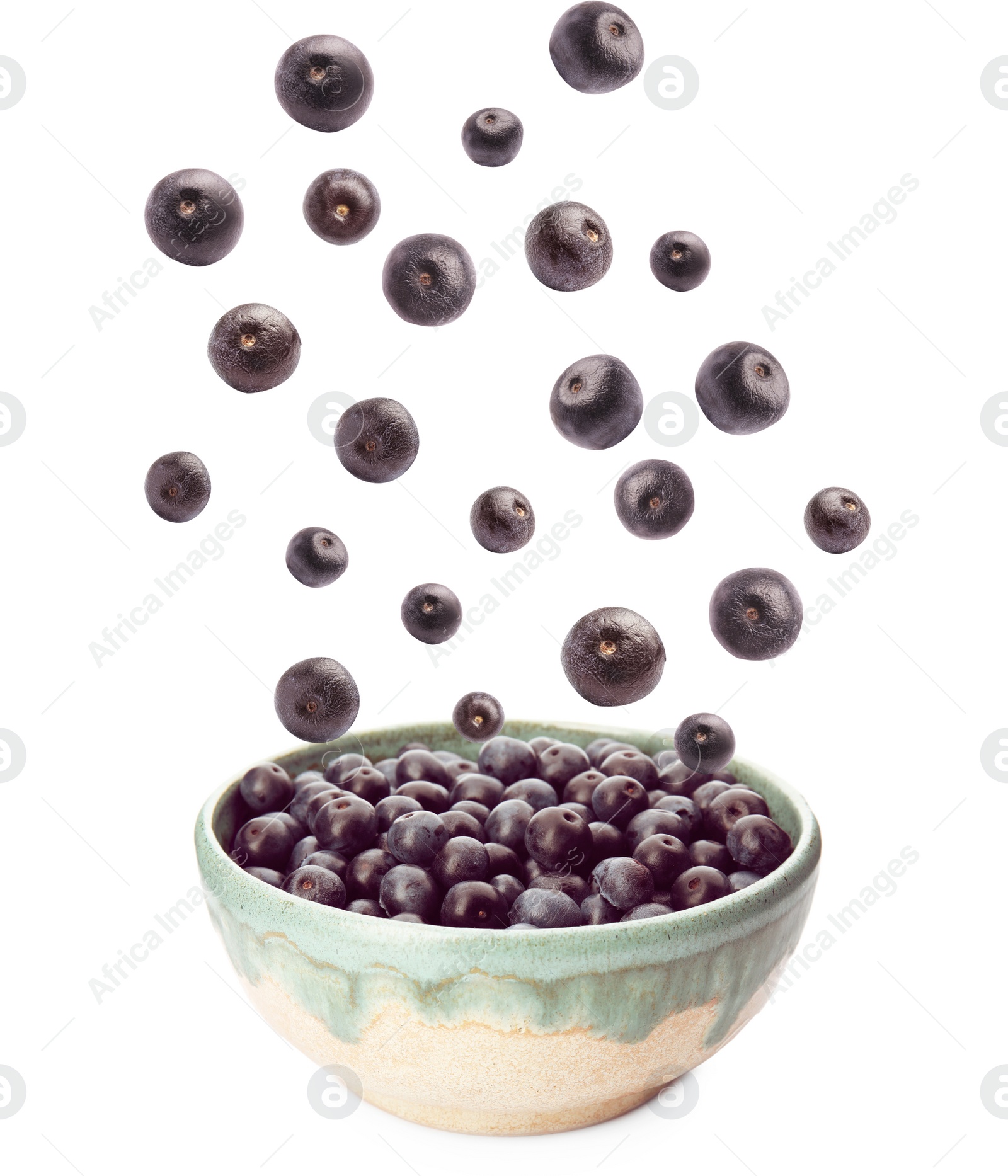 Image of Fresh acai berries falling into bowl on white background
