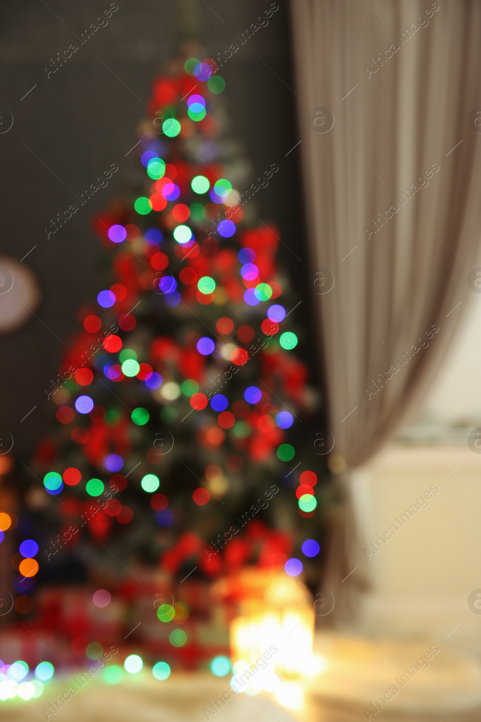 Photo of Blurred view of stylish room interior with decorated Christmas tree