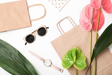 Photo of Stylish flat lay composition with shopping bags on color background